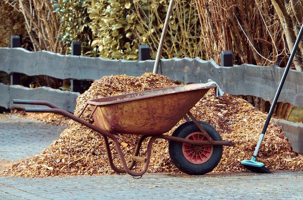 wheelbarrow and large pile of mulch