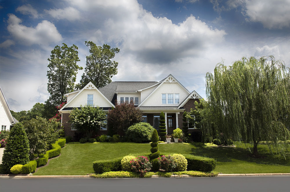 single-family home with a nicely landscaped and manicured lawn